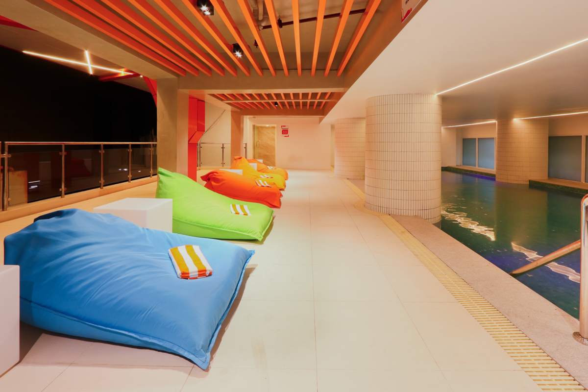 Vibrant indoor pool with tiled columns