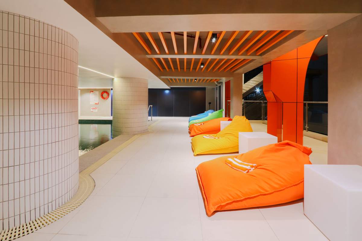 Poolside lounge pillows in orange, yellow, green and blue