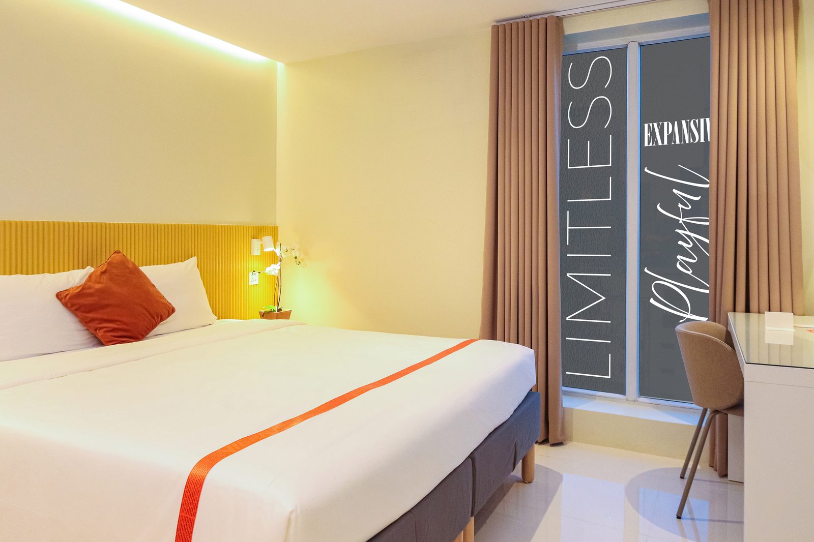 Deluxe Vibe room with queen bed, work desk and city-view window